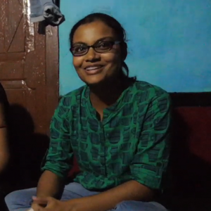 A woman smiling while telling a story