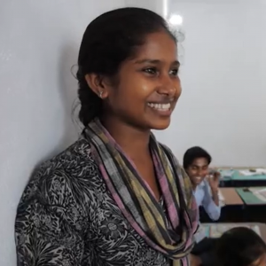 A woman smiling while telling a story